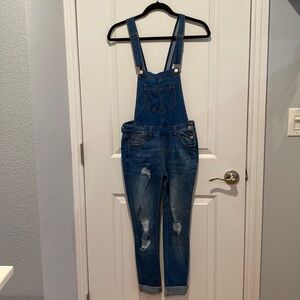 Distressed denim overalls